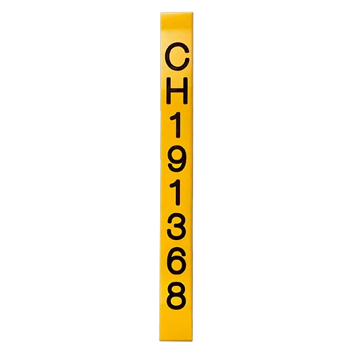 A narrow yellow utility marker printed vertically with an identification code.